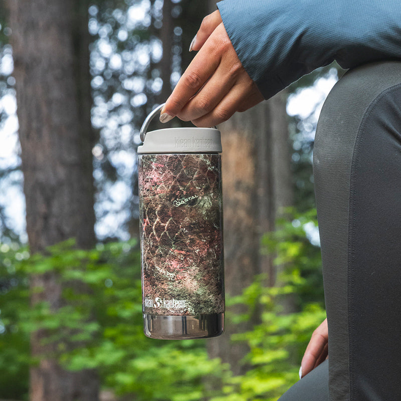 12oz-tkwide-with-cafe-cap-mossy-oak-l8 12oz_tumbler_mossyoak_rainbowtrout_hand_closeup_square.jpg