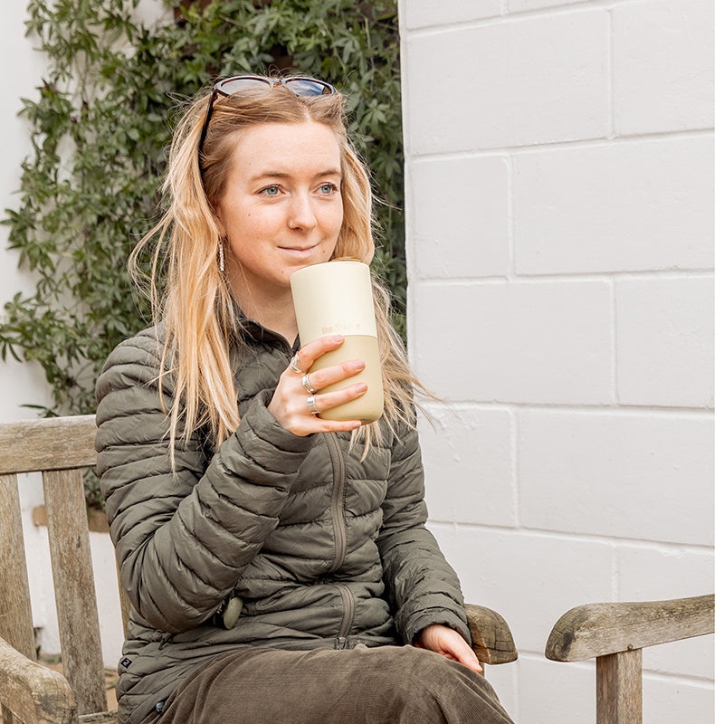 16oz-rise-tumbler-k1 16oz_rise_tumbler_wax_yellow_woman_seat_outside_square.jpg