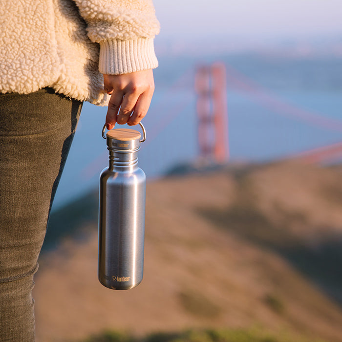 27oz-reflect-with-bamboo-cap-u0 K27SSLRF-BS-BAMBOO_reflect_bottle_bridge_lifestyle.jpg